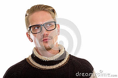Young handsome man thinking and looking up while wearing eyeglas Stock Photo