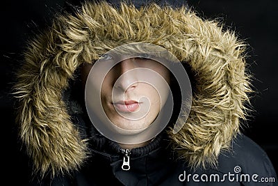 Young handsome man wearing fur hood in a winter Stock Photo