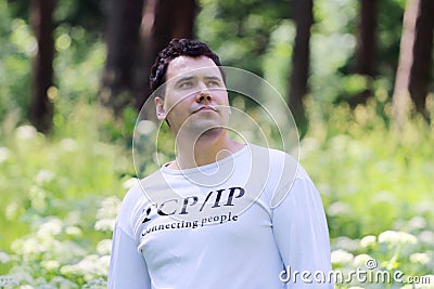 Young handsome man in white looks up Stock Photo