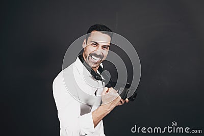 Young handsome photographer with beard and mustache studio portrait Stock Photo
