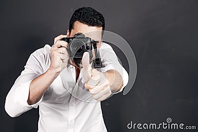 Young handsome photographer with beard and mustache studio portrait Stock Photo
