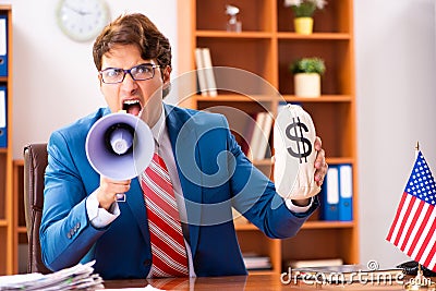 The young handsome politician sitting in office Stock Photo