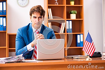 The young handsome politician sitting in office Stock Photo