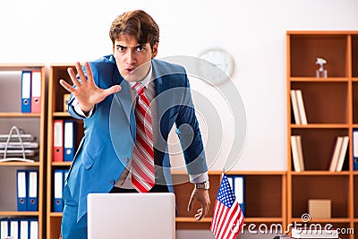 The young handsome politician sitting in office Stock Photo