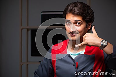 The young handsome repairman repairing computer Stock Photo