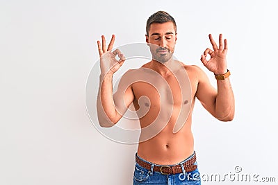 Young handsome shirtless man showing muscular body over isolated background relax and smiling with eyes closed doing meditation Stock Photo