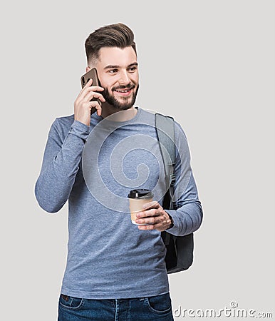 Young handsome smiling man talking on mobile phone isolated studio shot Stock Photo