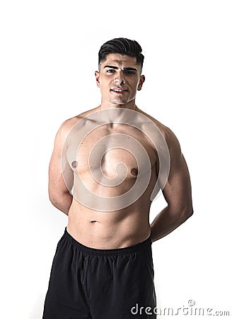 Young handsome sport man posing with strong ripped naked torso looking cool and happy isolated on white Stock Photo