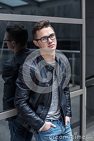 Young handsome student guy in black Leather Jacket Stock Photo