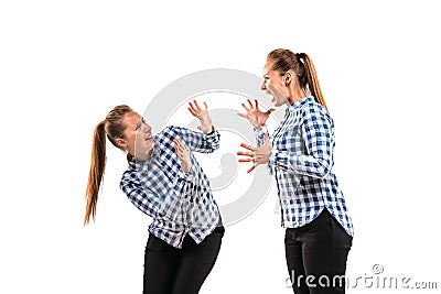 Young handsome woman arguing with herself on white studio background. Stock Photo