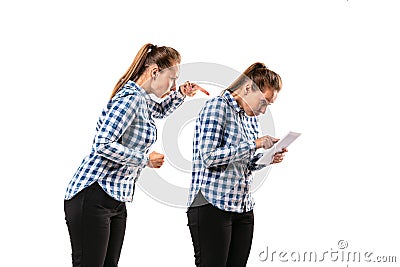 Young handsome woman arguing with herself on white studio background. Stock Photo