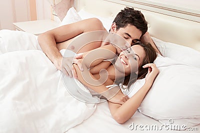 Young adult couple in bedroom Stock Photo