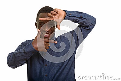 Young happy African man smiling and focusing with fingers Stock Photo