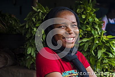 young happy african woman selling in a local market laughing Stock Photo