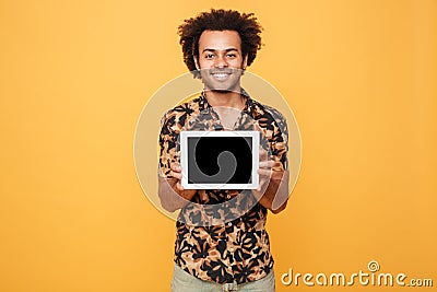 Young happy afro american man showing blank screen pc tablet Stock Photo