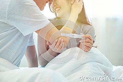 Young happy asian couple with encourage and hug together with pregnancy test.Expecting mom with cheerful face with pregnancy in Stock Photo