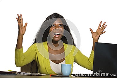 Young happy and attractive black afro American business woman smiling cheerful and confident working at office computer desk celeb Stock Photo