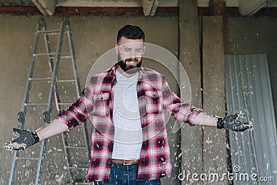 Young happy bearded man hipster carpenter in construction glasse Stock Photo