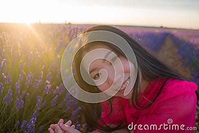 Young happy and beautiful Asian Chinese woman in Summer dress enjoying free and playful in romantic and lovely purple lavender Stock Photo