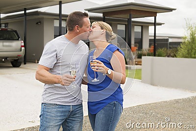 Young happy and beautiful couple in love drinking champagne or wine having sweet toast celebrating anniversary or valentines day o Stock Photo