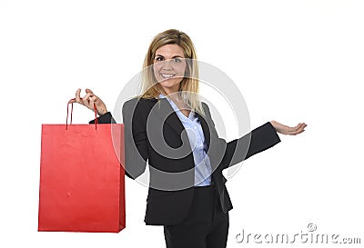 Young happy beautiful woman in business suit in excited face expression holding red shopping bag Stock Photo