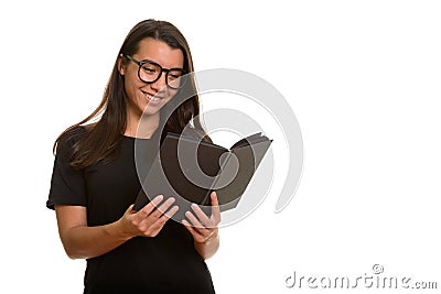 Young happy Caucasian woman smiling and reading book Stock Photo