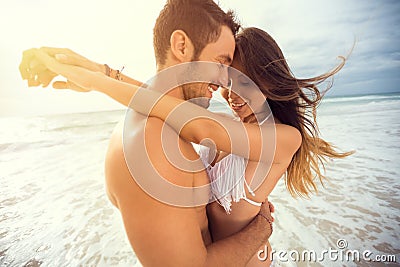 Young happy couple with draw heart on tropical beach Stock Photo