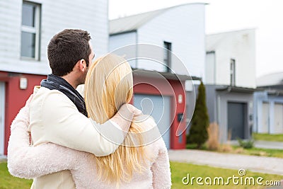 Young happy couple in front of their new house Stock Photo