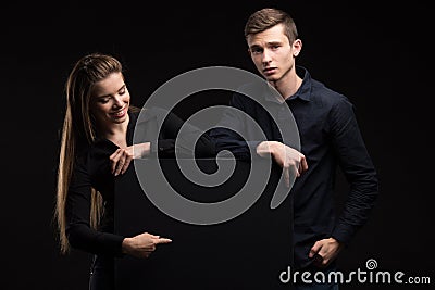 Young happy couple showing presentation pointing on placard Stock Photo