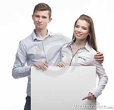 Young happy couple showing presentation pointing on placard Stock Photo