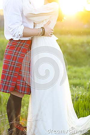 Young happy couple together hand in hand in sunset Stock Photo