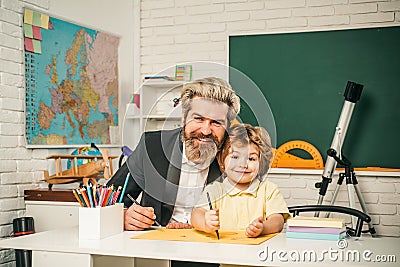 Young happy family father and son schooling math together. Education background. Elementary school tutorship. Stock Photo