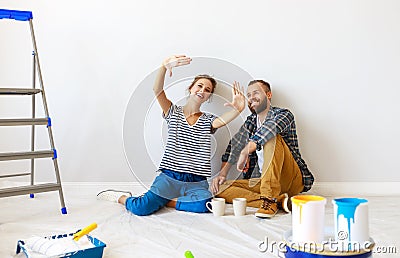 Young happy family married couple dreams of renovating house and planning design project Stock Photo
