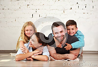 Young happy family parents and two children home studio Stock Photo