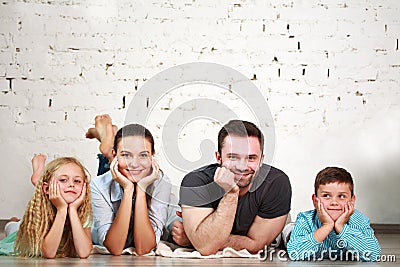 Young happy family parents and two children home studio Stock Photo