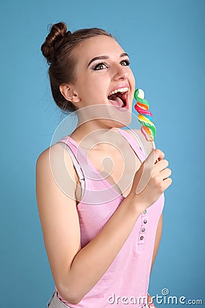 Young happy girl with colored candy Stock Photo