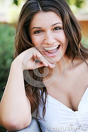 Young happy girl with long hair posing outdoor. Stock Photo