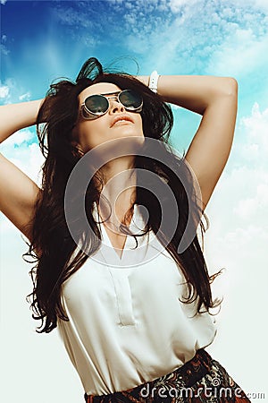 Young girl in sunglasses against the sky Stock Photo