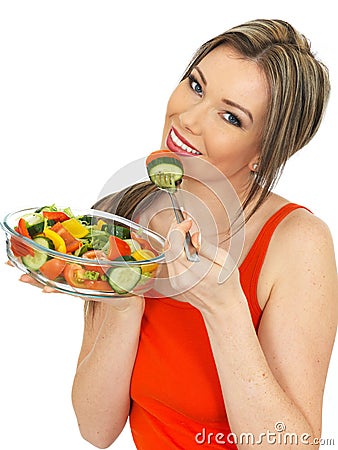 Young Happy healthy Woman Eating a Fresh Mixed Garden Salad Stock Photo