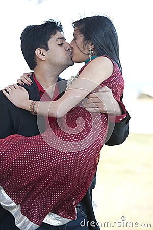 Young Happy Indian Couple Kissing Stock Photo