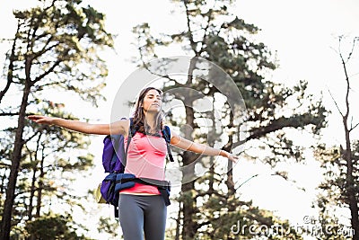 Young happy jogger standing on rock feeling free Stock Photo