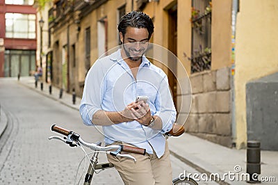 Young happy man smiling using mobile phone on vintage cool retro bike Stock Photo