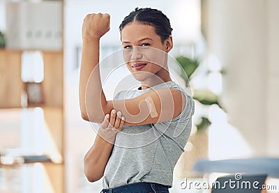 Young happy mixed race woman showing and holding her arm with a bandaid after getting a vaccine. Beautiful and confident Stock Photo