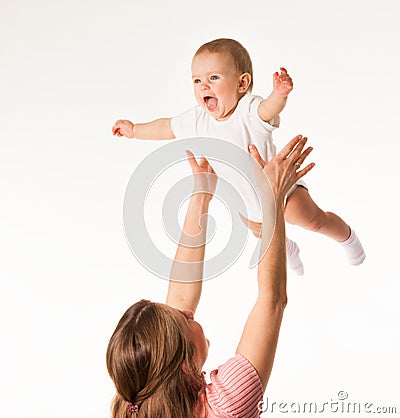 Young happy mom throws up her charming baby Stock Photo