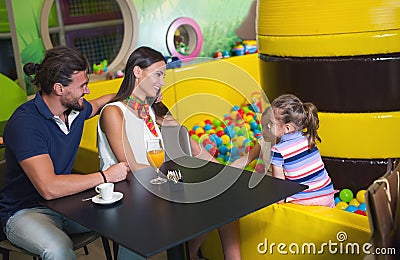 Happy parents having fun with kids in children playground Stock Photo