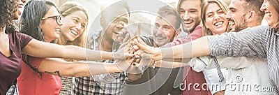 Young happy people stacking hands outdoor - Diverse culture students celebrating together - Youth lifestyle, university, Stock Photo