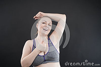 Young happy plus size caucasian woman shows her unshaved armpit Stock Photo