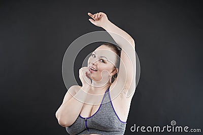 Young happy plus size caucasian woman shows her unshaved armpit Stock Photo