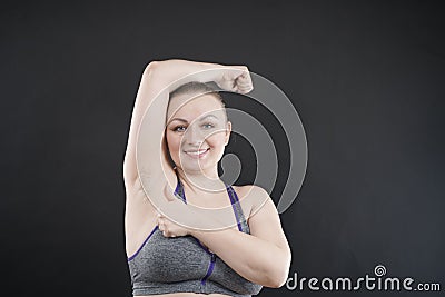 Young happy plus size caucasian woman shows her unshaved armpit Stock Photo