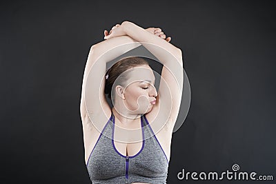 Young happy plus size caucasian woman shows her unshaved armpit Stock Photo